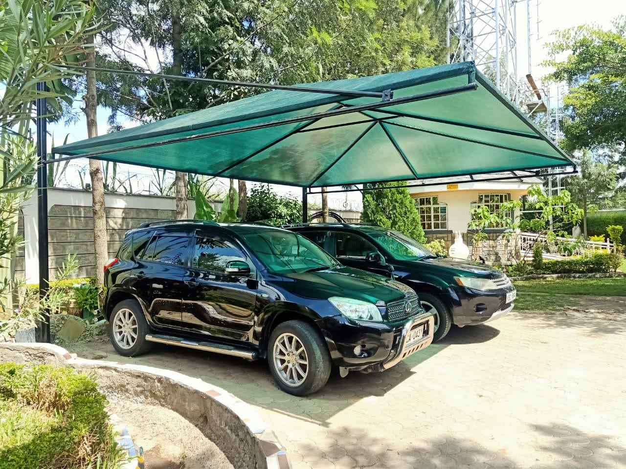 Completed steel car parking shade structure covering SUVs, supplied and installed by Elatec